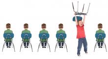five children sit on chairs one child stands with chair held over head
